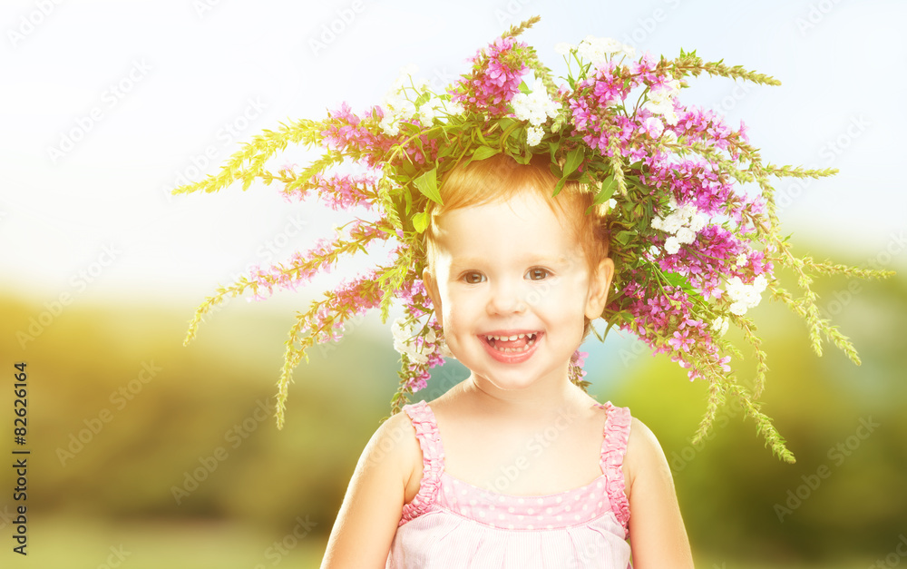happy little baby girl child in summer wreath