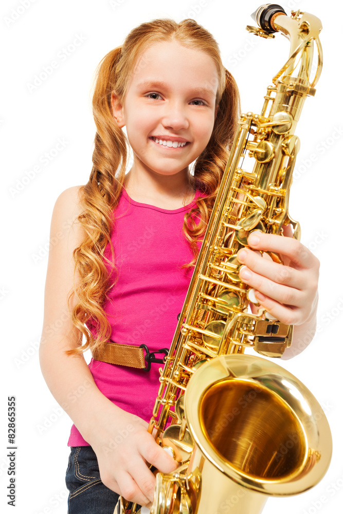 Portrait of happy girl playing alto saxophone
