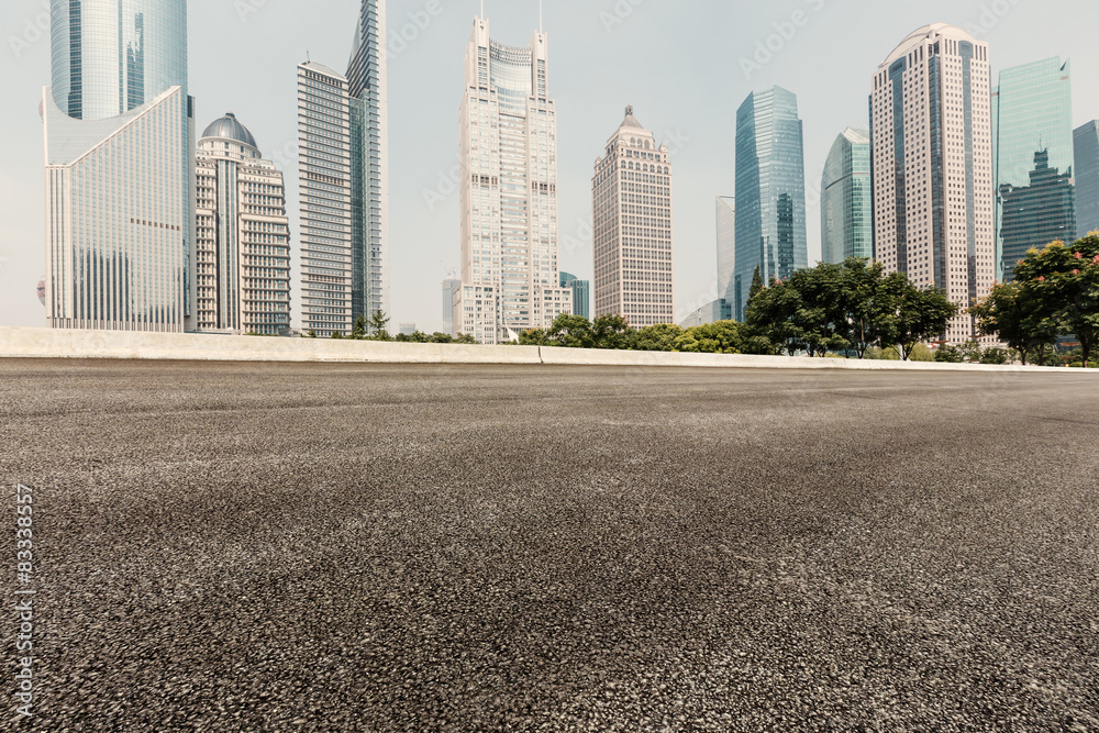 Asphalt road in front of the modern building， in Shanghai，china。