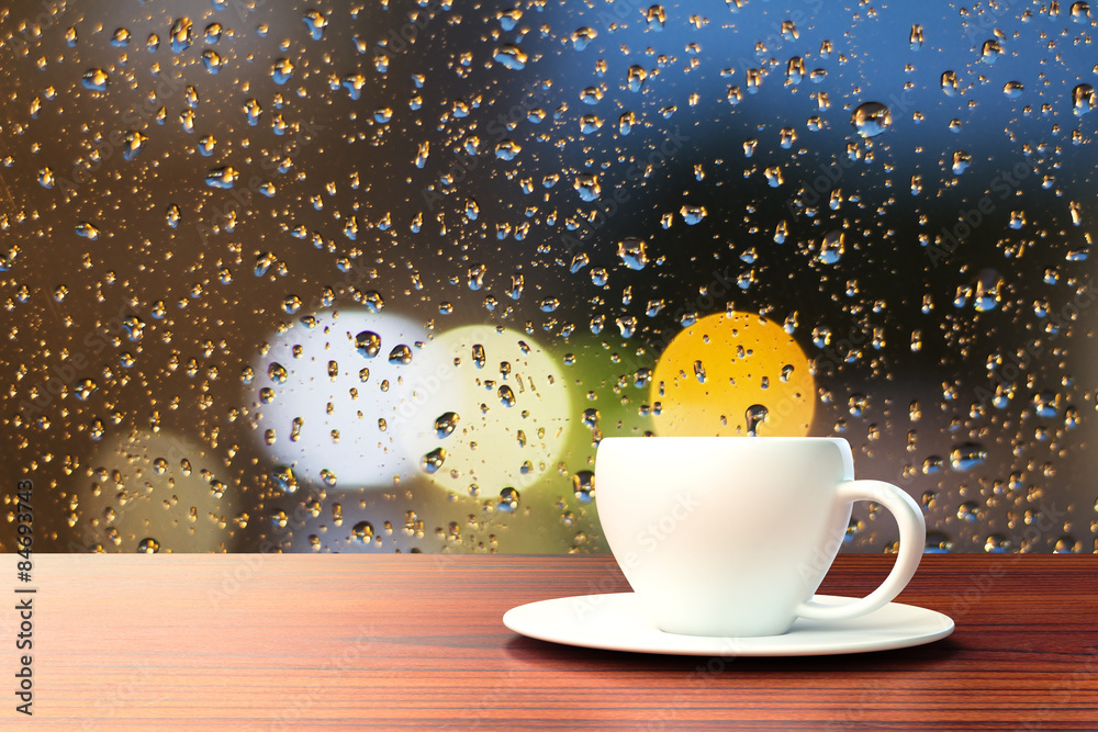 一杯咖啡在有雨滴的窗户背景上