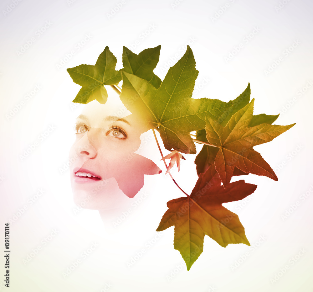 Double exposure of woman with tree leaves