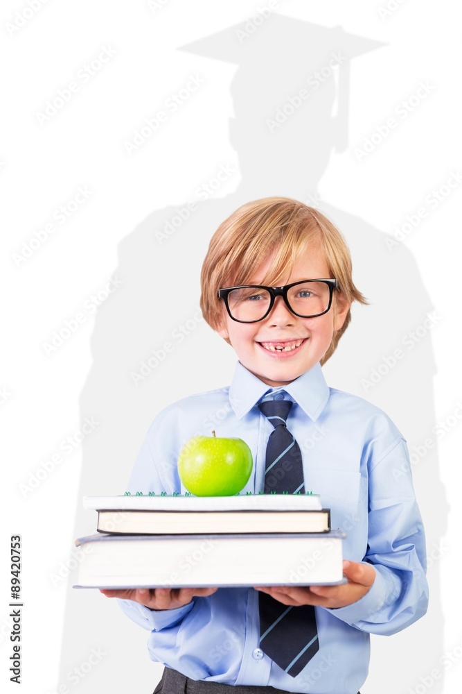 可爱的小学生拿着书和苹果的合成图