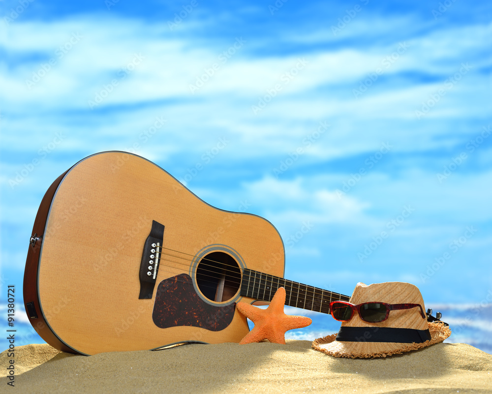 夏季沙滩上的声学吉他，碧海蓝天