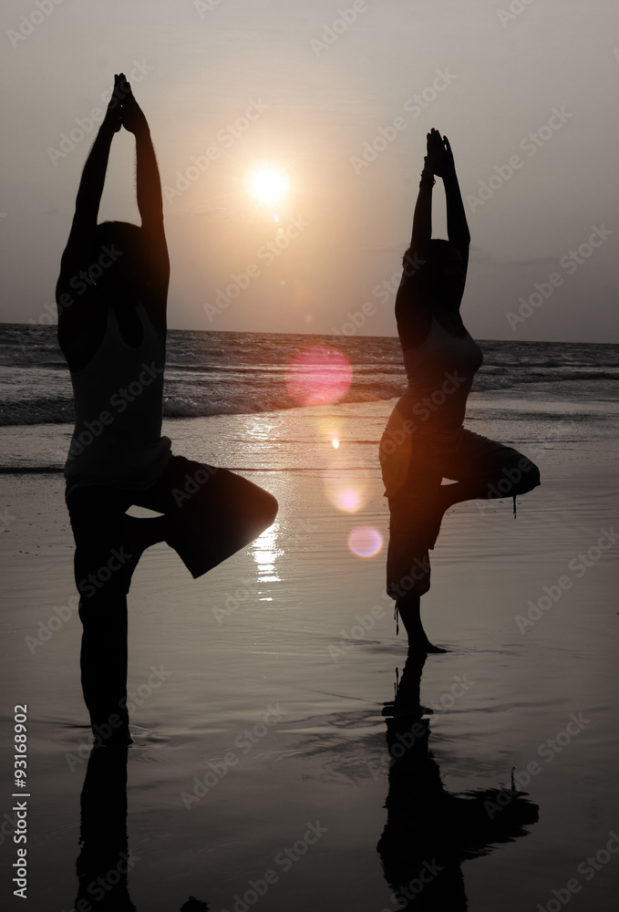 Serene People In The Beach Doing Yoga In The Sunset Concept