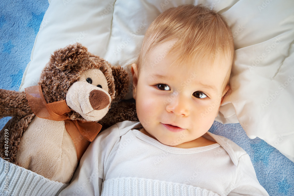 One year old baby with a teddy bear