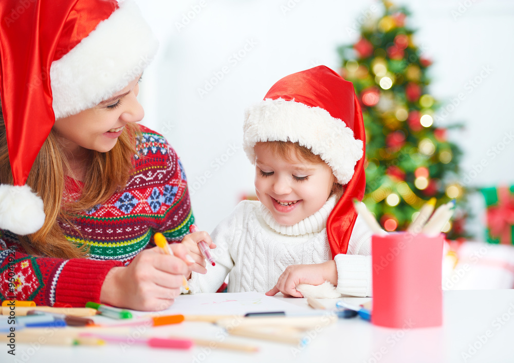 happy family mother and child daughter  write aletter to Santa o
