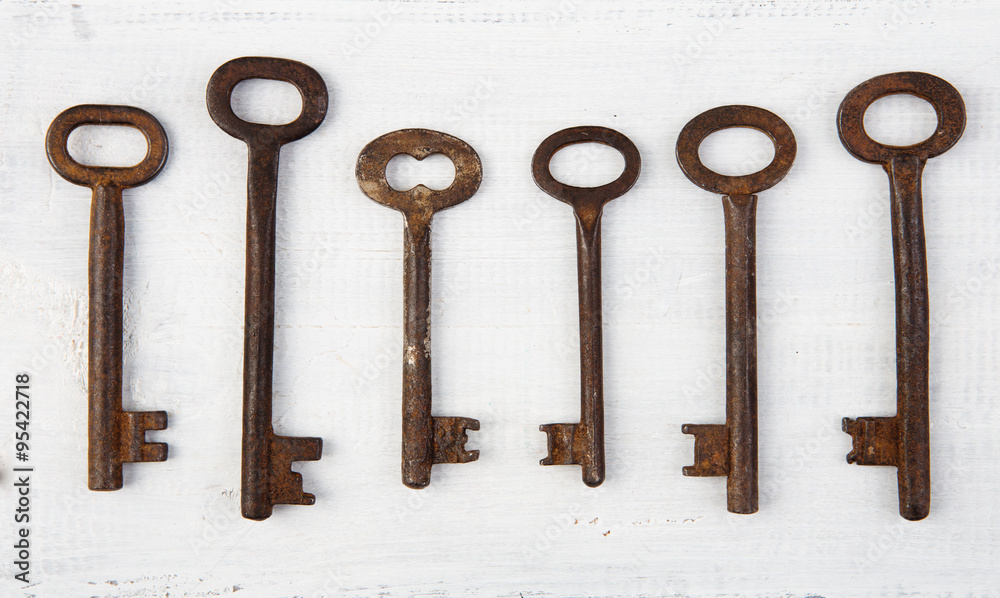 Set of vintage door keys on wooden background