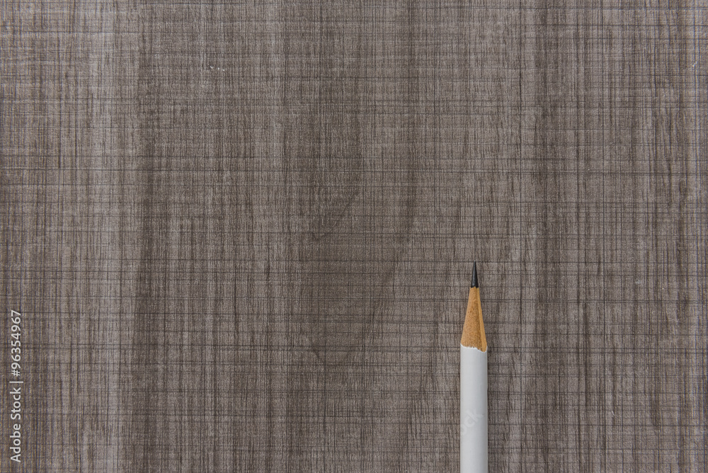 white pencil on wooden table
