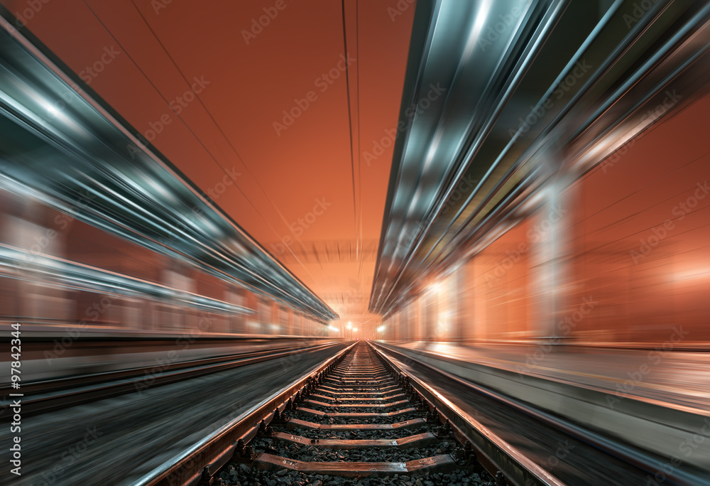 Railway station at night with motion blur effect. Railroad