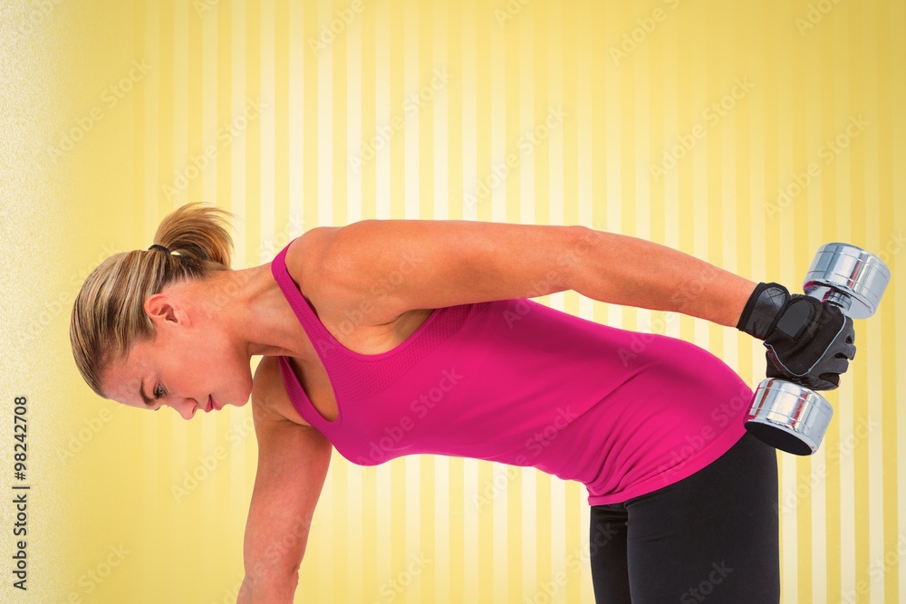 Composite image of muscular woman exercising with dumbbells 