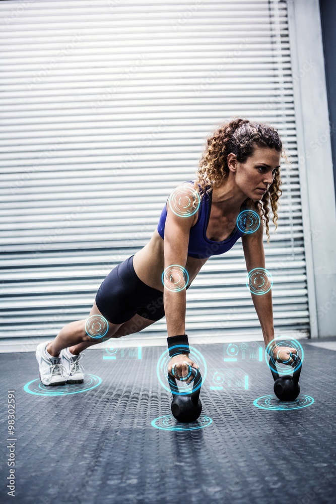 Composite image of woman doing push-ups with kettlebells