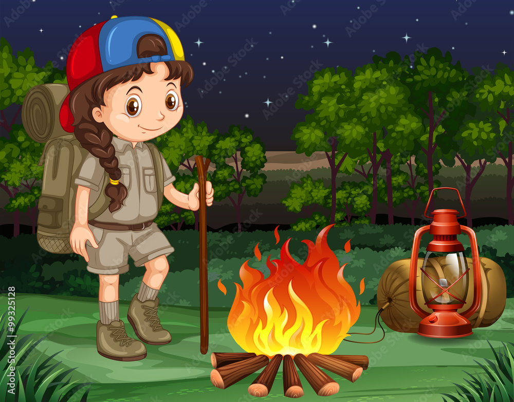 Little girl standing by the campfire
