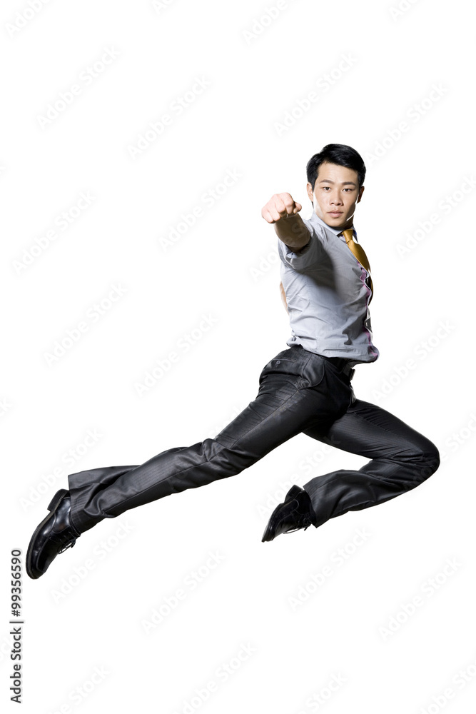 Businessman doing martial arts punch in mid air