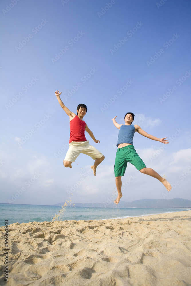 Two young men excited to be at the beach