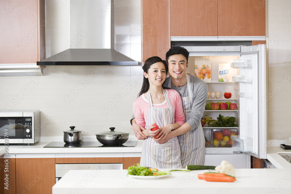 Happy young couple preparing meal