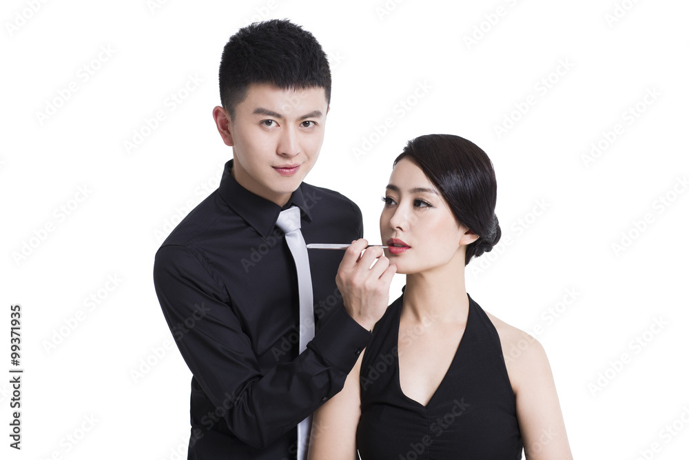 Makeup artist applying make-up to young woman