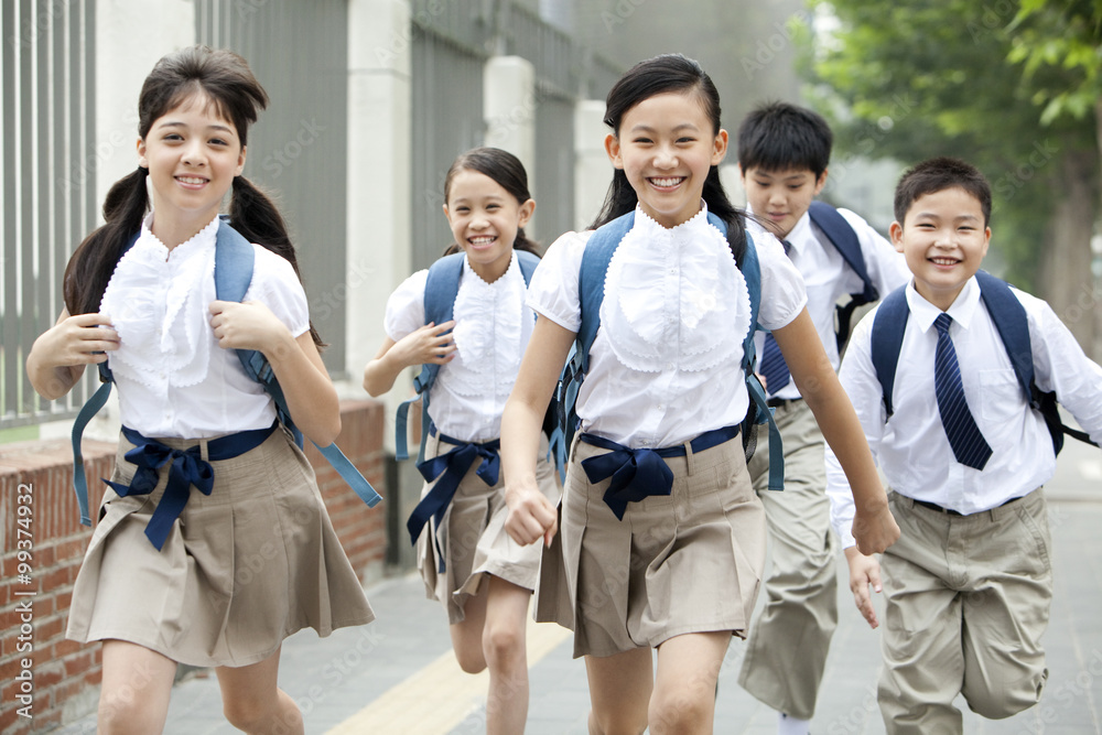 上学路上穿着校服的活泼学童