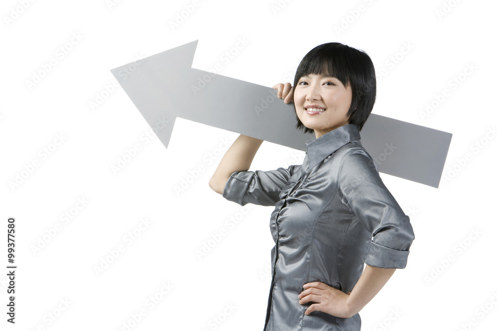 Young businesswoman holding arrow