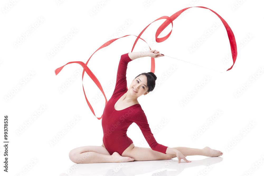 Female gymnast performing rhythmic gymnastics with ribbon
