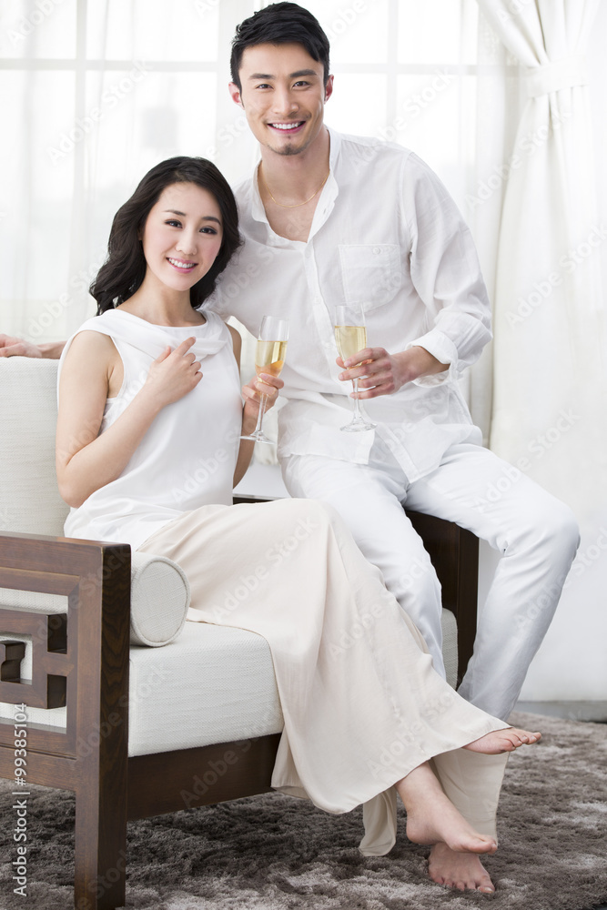 Cheerful young couple with champagne