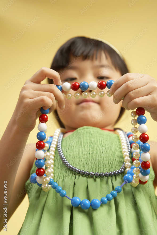 Girl Holding Bead Necklace