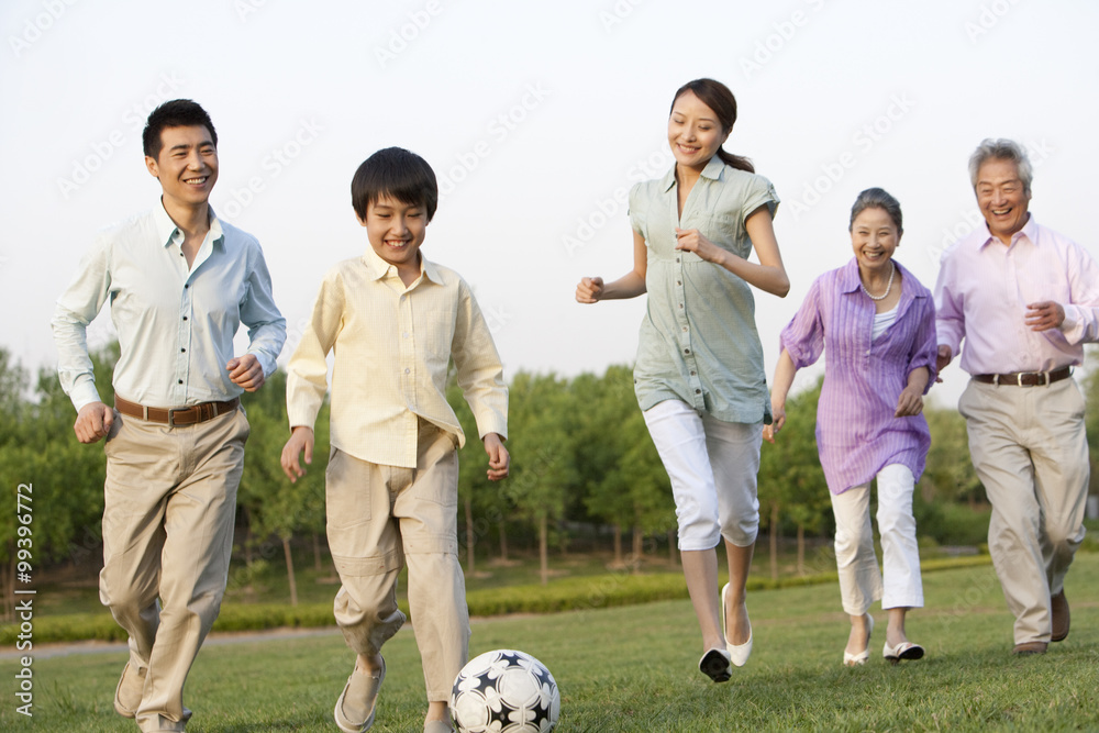 Family playing soccer together