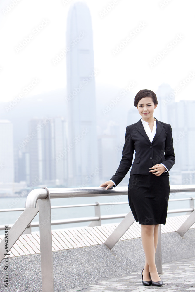 Elegant businesswoman in Victoria Harbor, Hong Kong