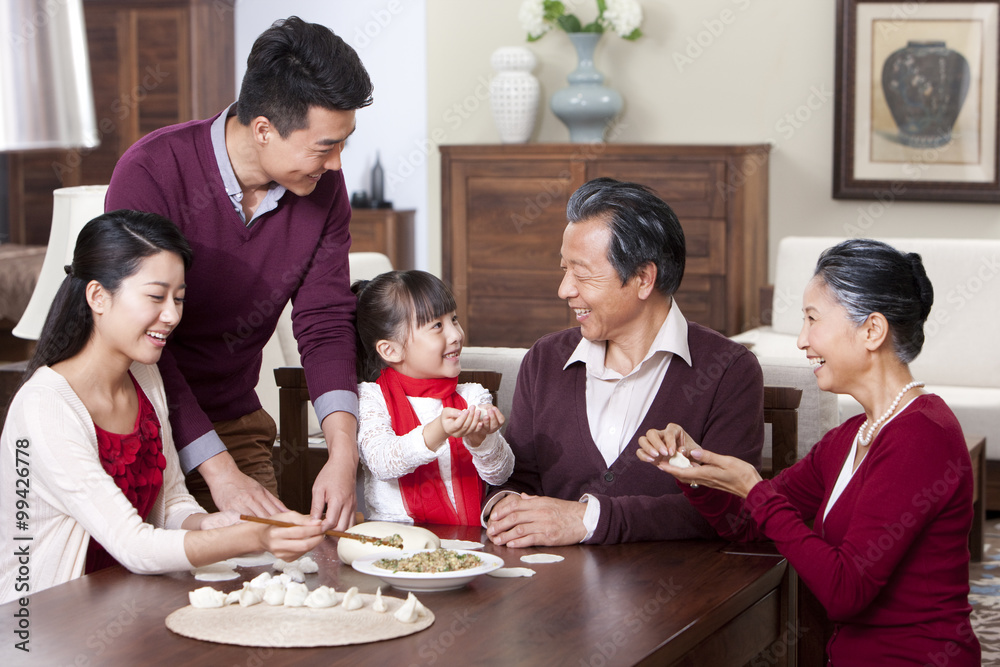 Happy family making Chinese dumplings during Chinese New Year