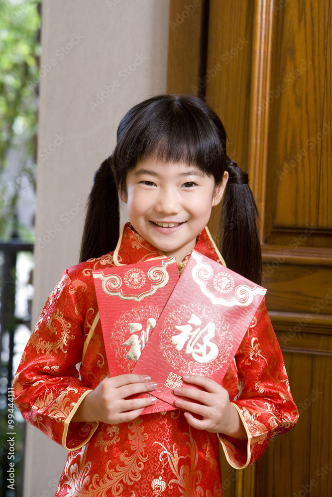 Portrait of a girl holding Chinese red envelope