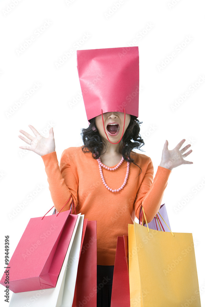 Young woman with shopping bag over her head