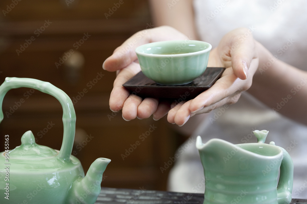 Young woman serving Chinese tea