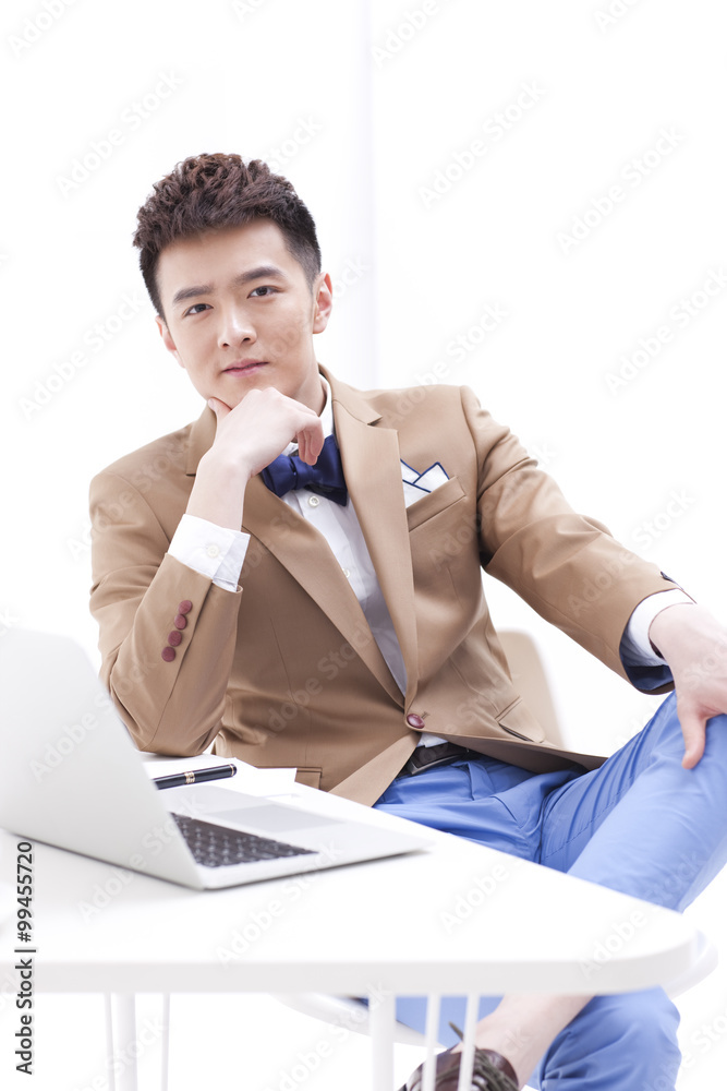 Stylish young businessman in office