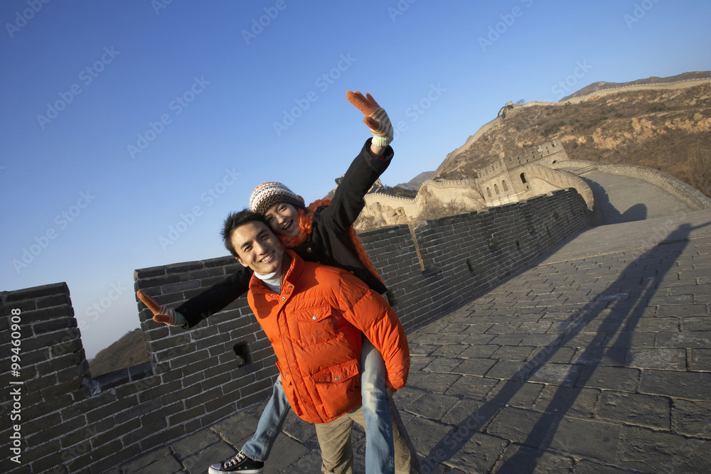 Man Giving Woman Piggy Back Ride On Great Wall Of China