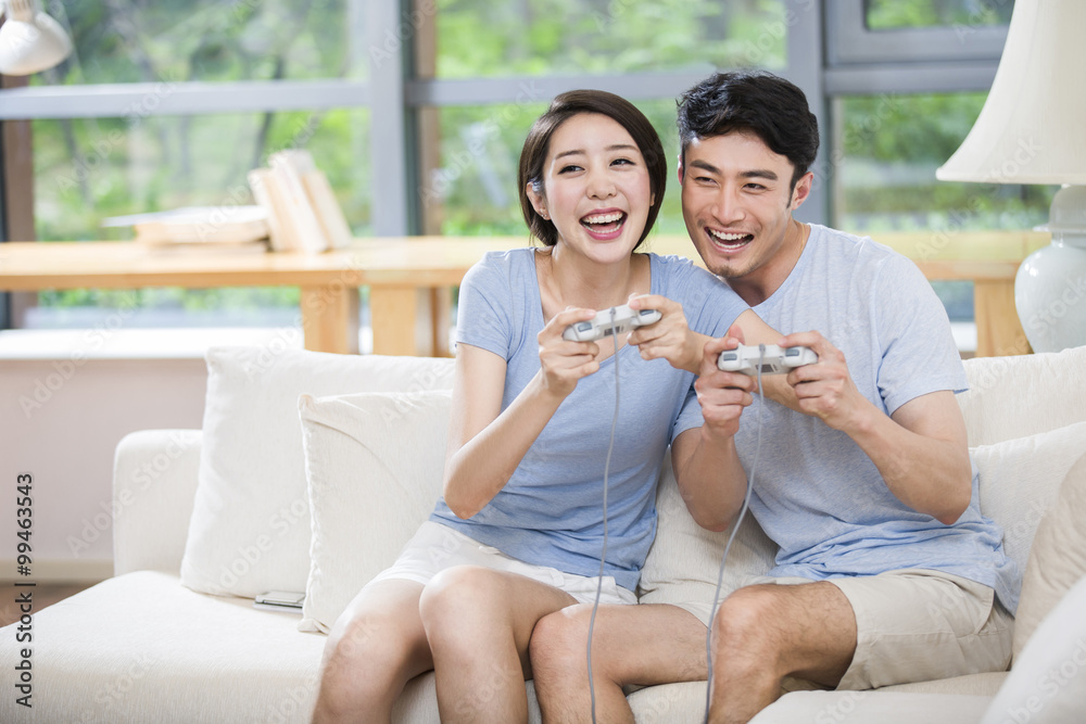 Young couple playing video games together