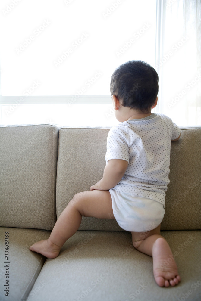 Infant looking out window