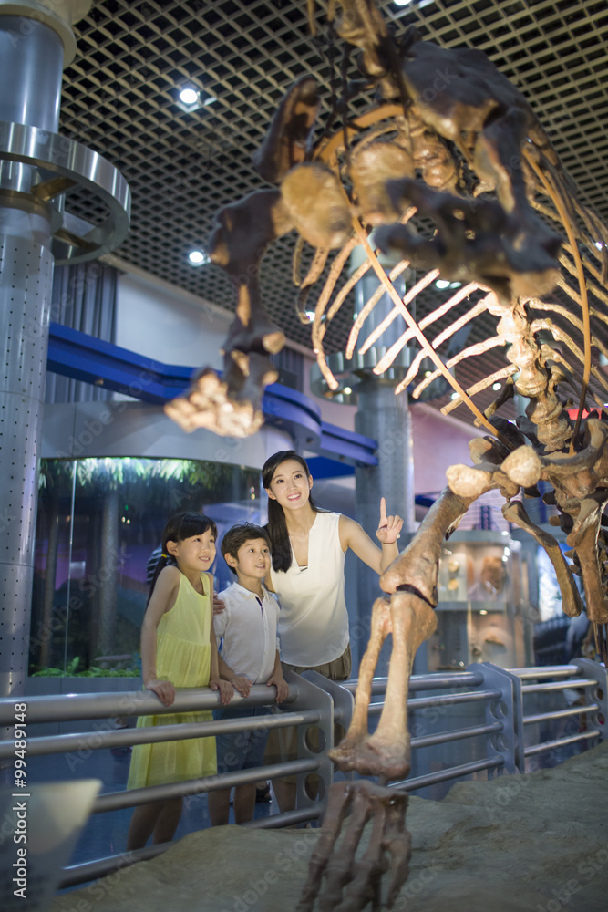Young mother and children in museum of natural history