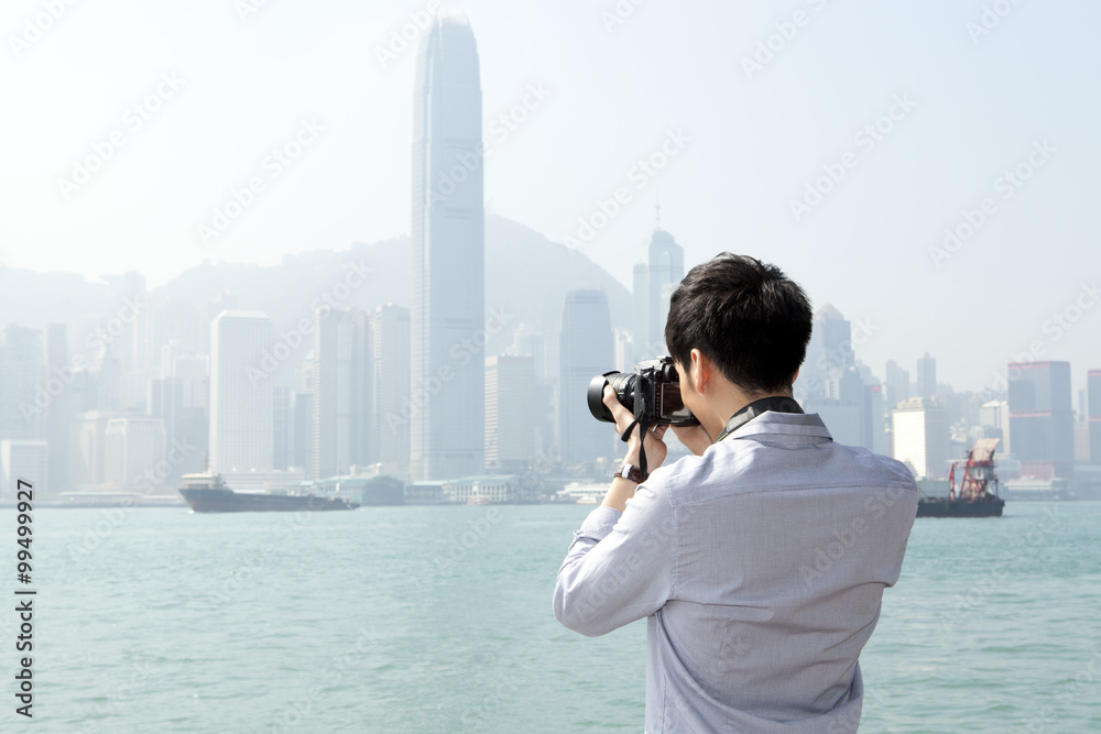 香港维多利亚港用单反相机拍摄年轻人