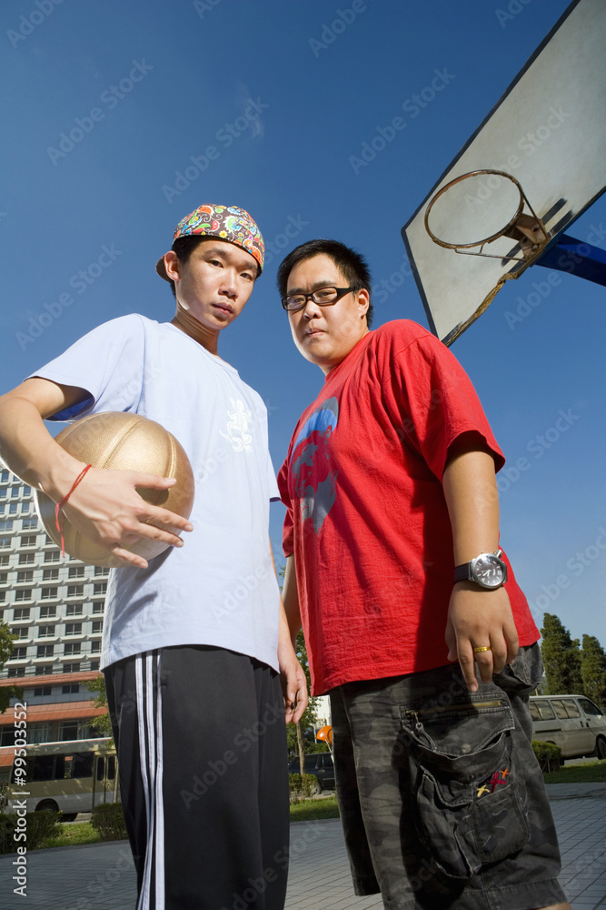 Teenage Boys Holding Basketball