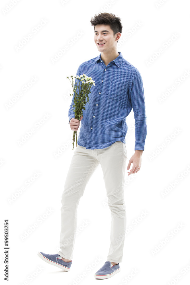 Young man holding a bunch of flowers