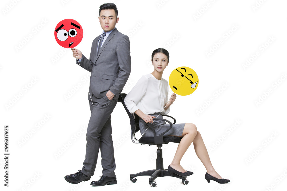 Business person holding embarrassed emoticon faces