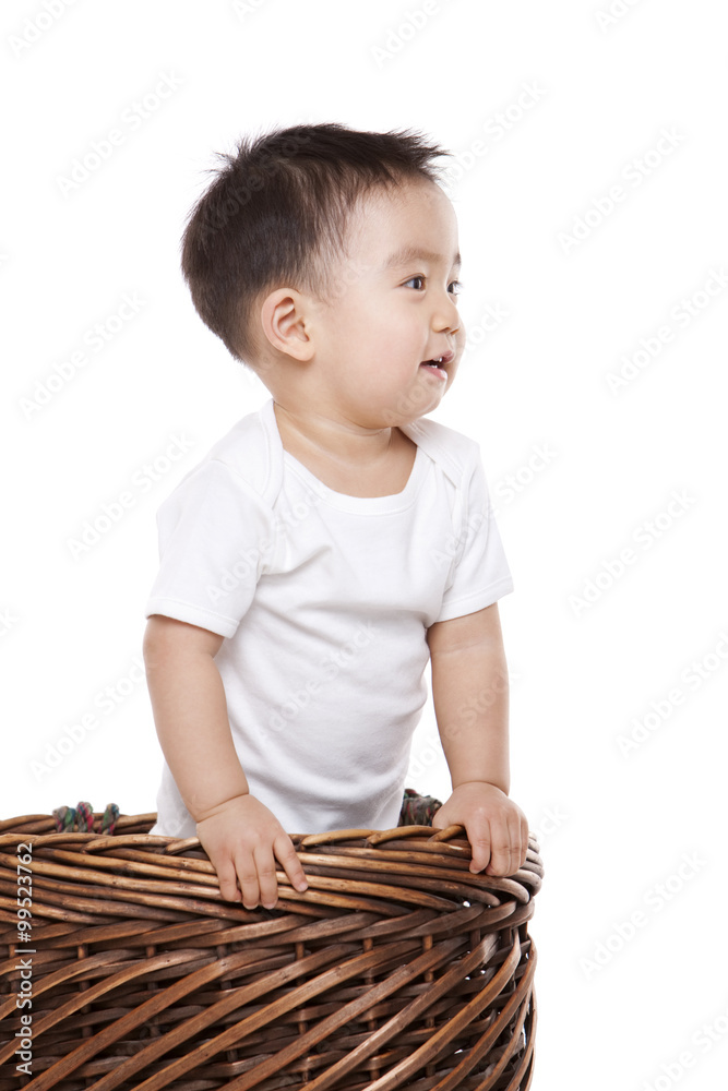 Happy baby boy in bamboo basket