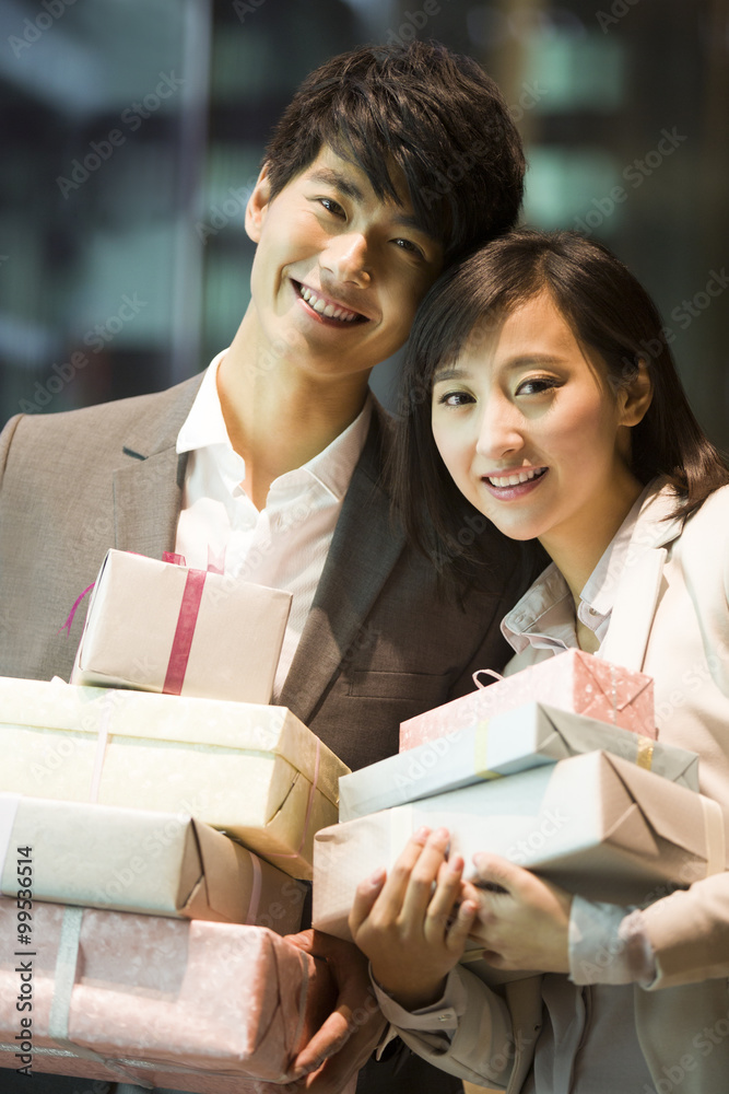 Happy young couple with gifts