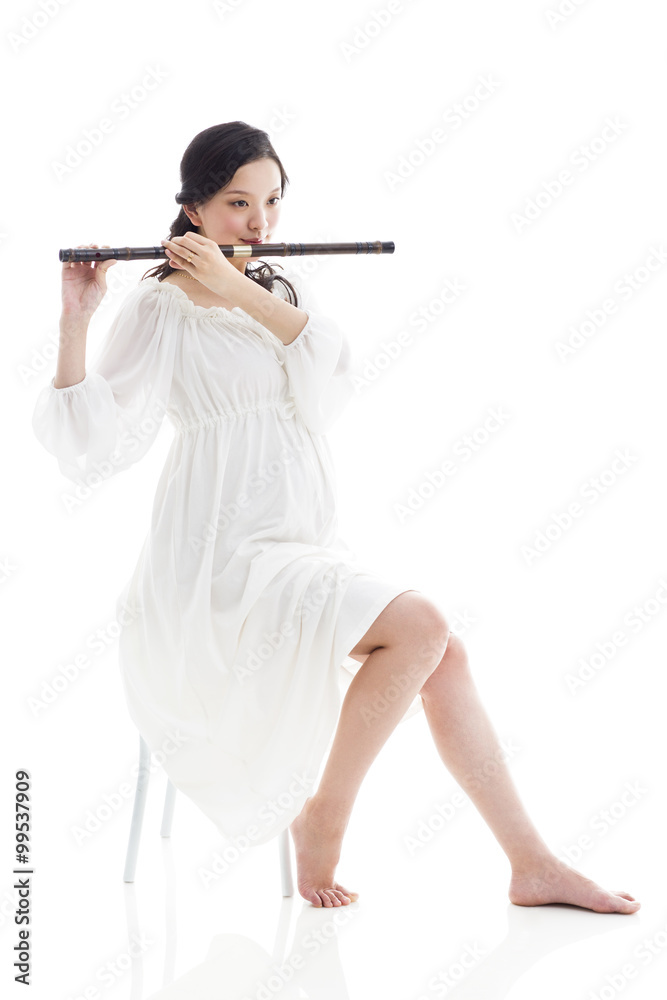 Pregnant woman playing flute
