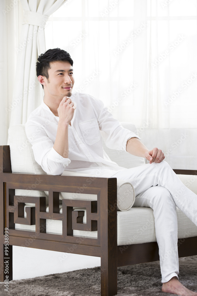 Young man resting in sofa
