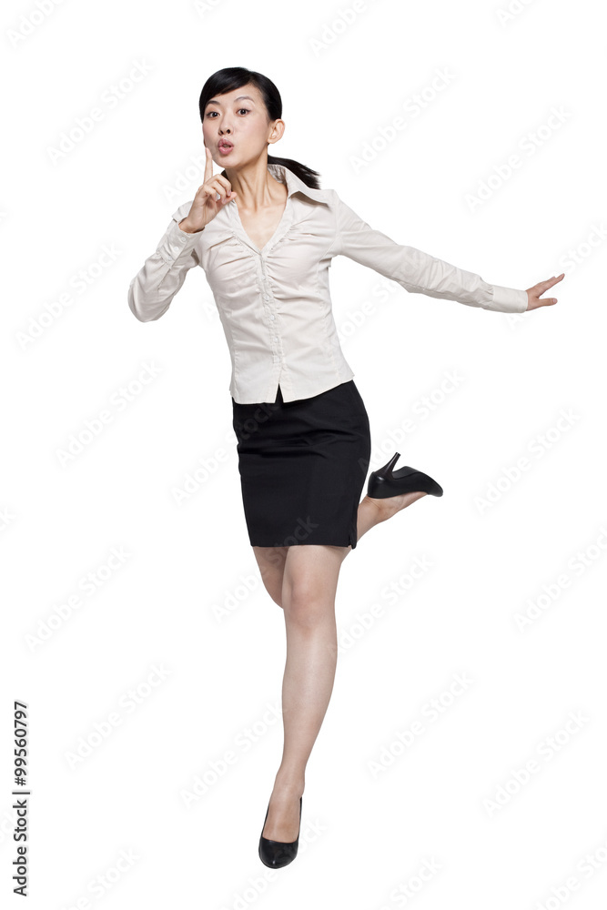 Businesswoman Jumping With Finger Over Mouth