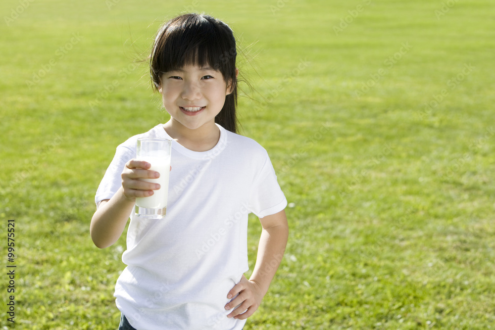 Young girl holding a glass of milk