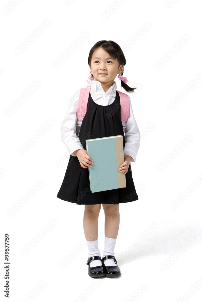 Little girl carries a book