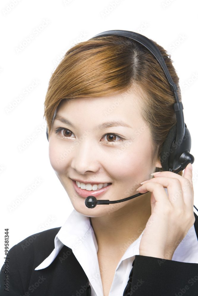 Young businesswoman wearing telephone headset, smiling, close-up,