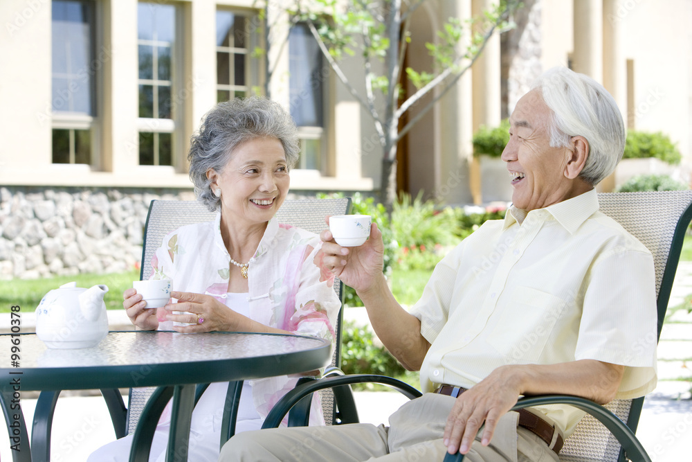 Senior couple chatting and having tea
