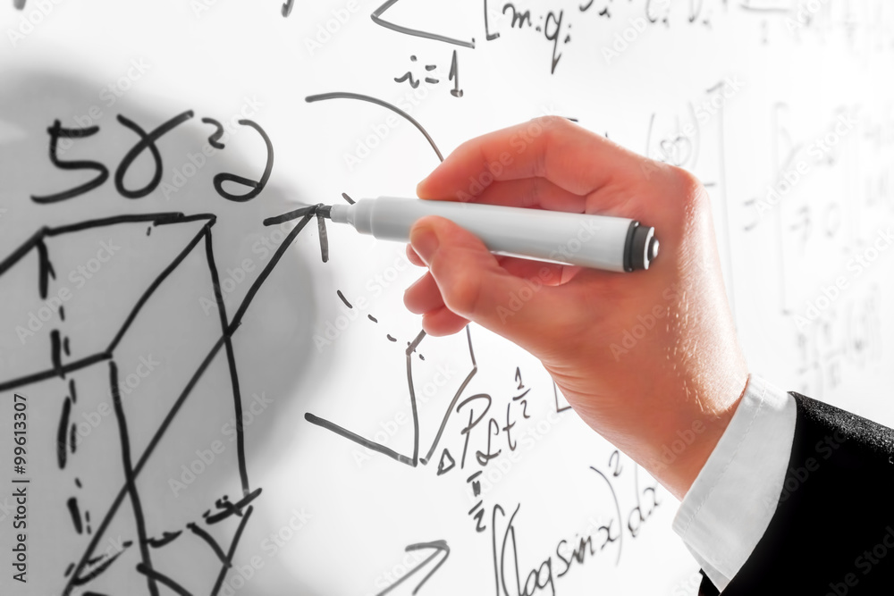 Man writing complex math formulas on whiteboard. Mathematics and science